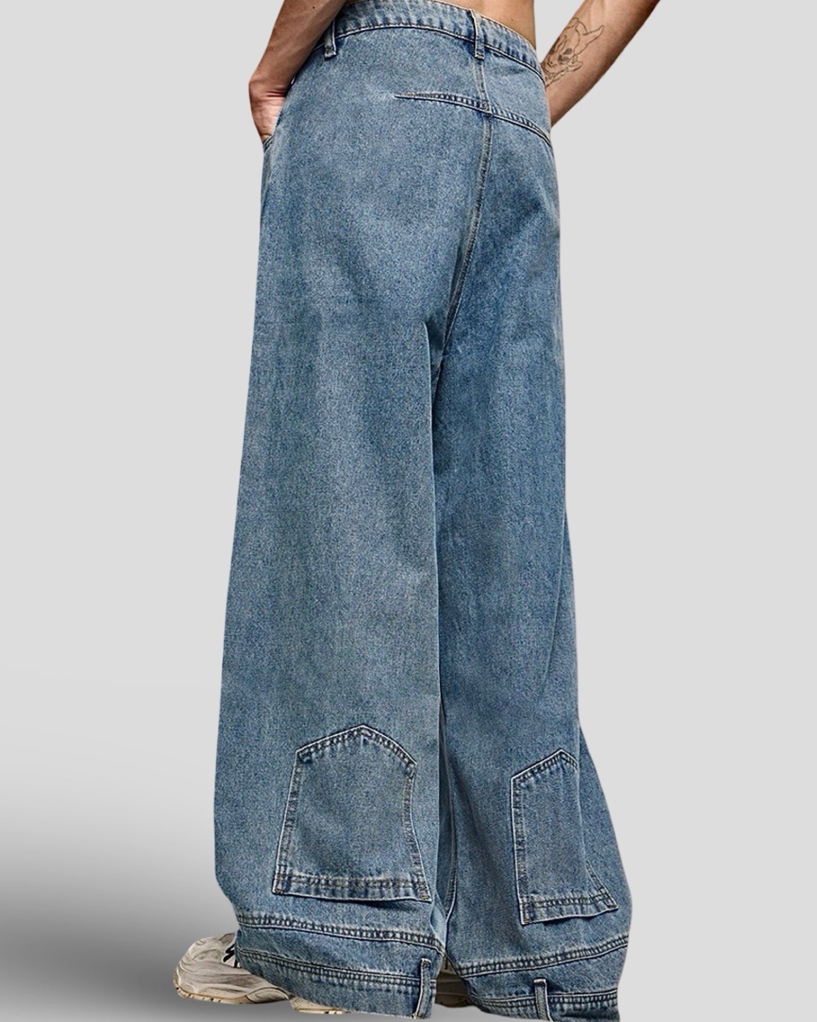 man wearing wide leg mid rise unisex light blue vintage washed denim jeans with