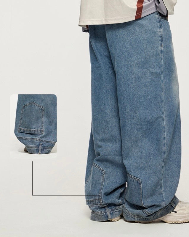 model wearing wide leg mid rise unisex light blue vintage washed denim jeans with