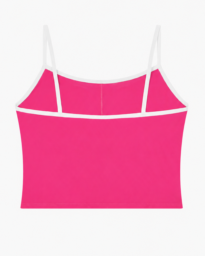 Pink crop top with thin white straps on a white background