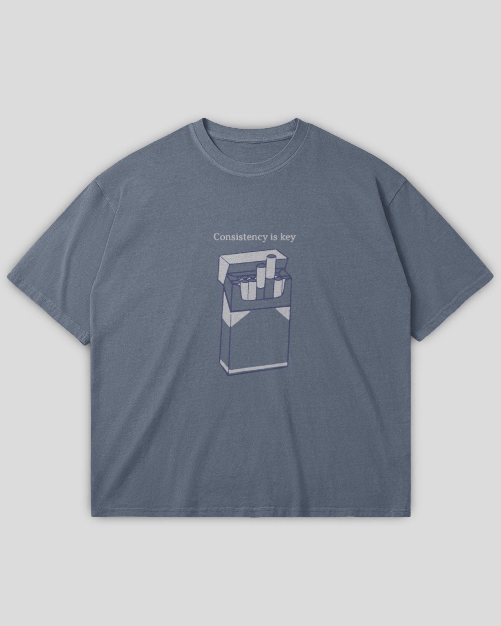 flat lay image of an oversized vintage wash gray heavyweight cotton t-shirt with an embroidered graphic design that reads 
