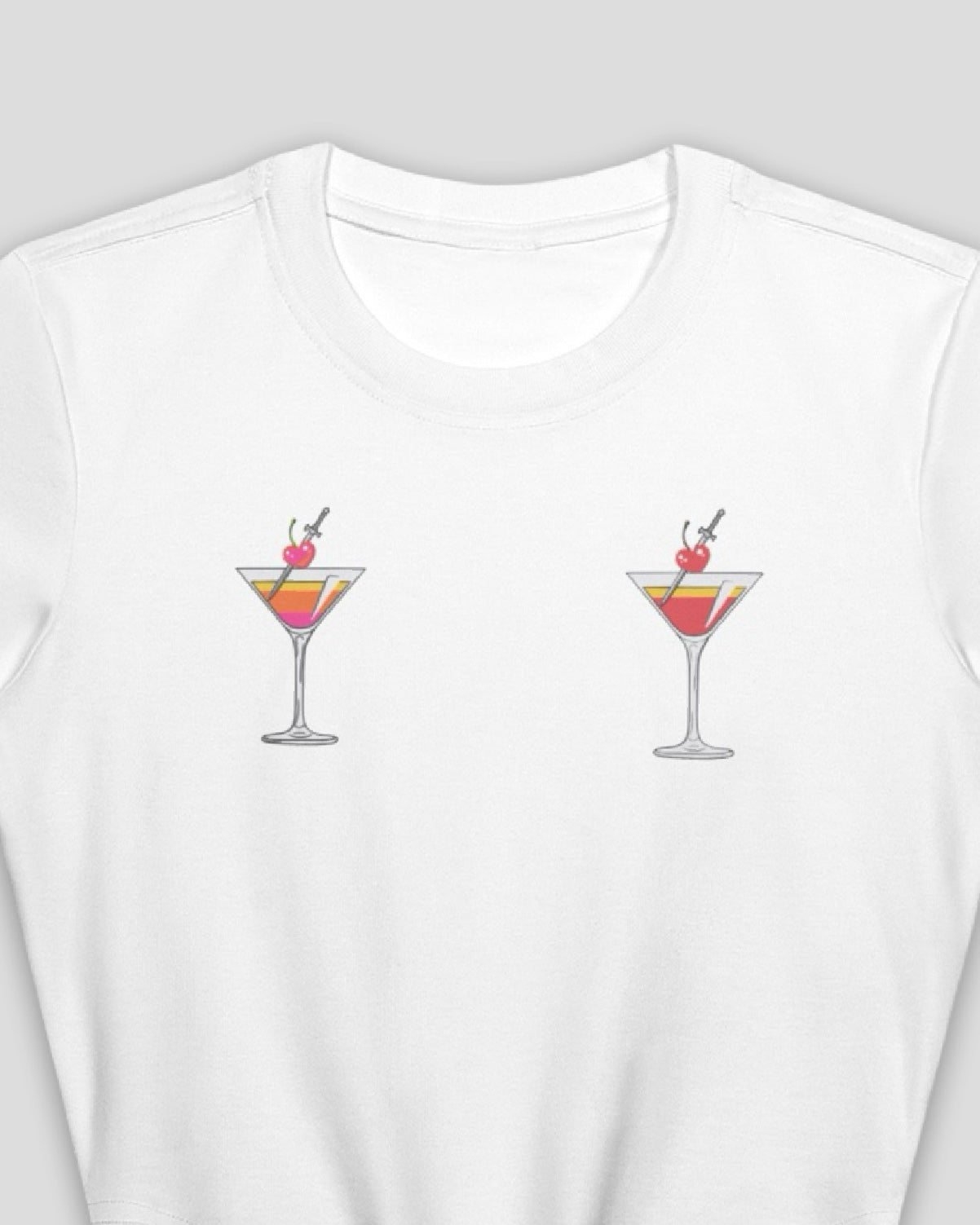 close up of a white cotton crop top baby tee with embroidered martini design across chest against a white background