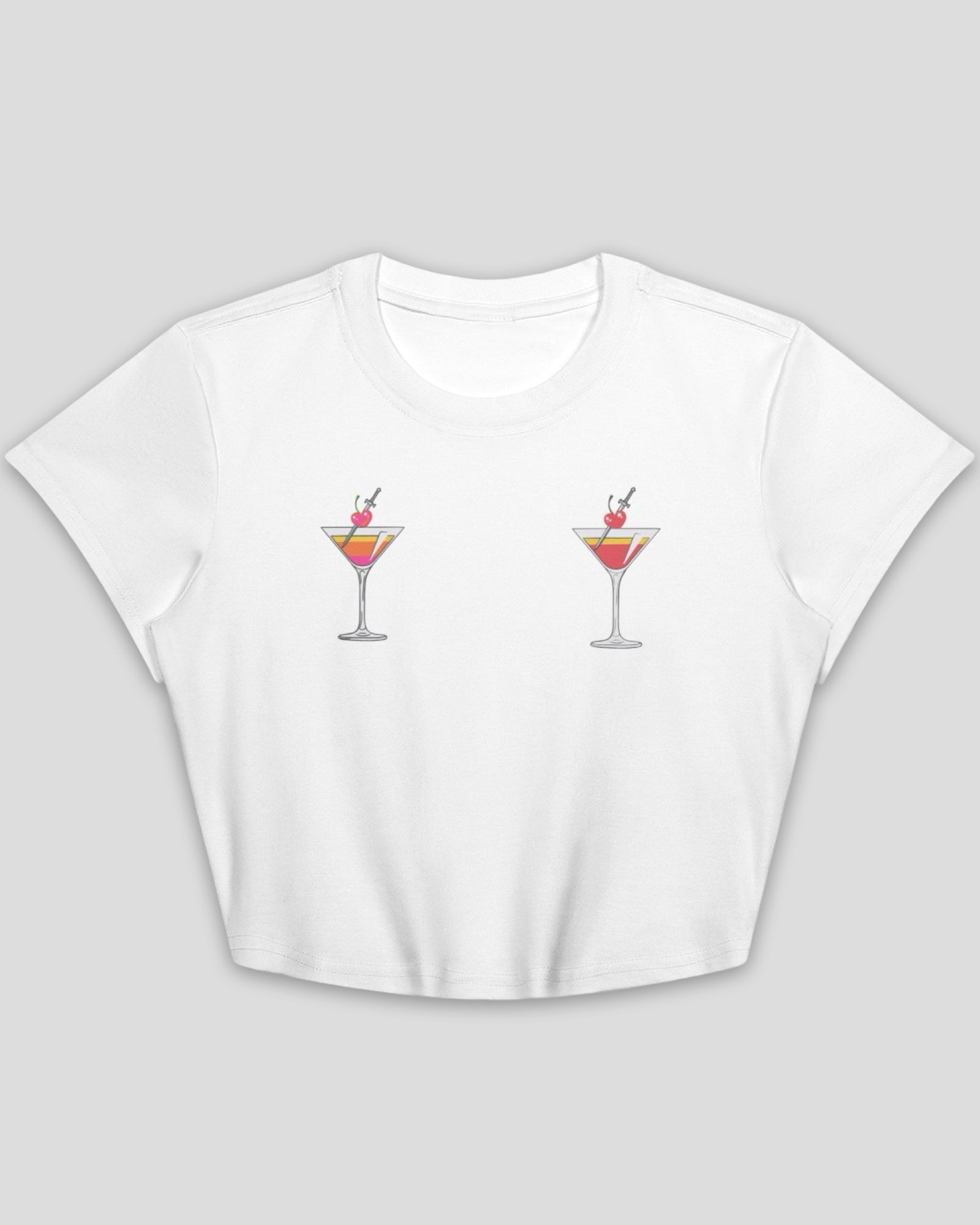 flat lay of a white cotton crop top baby tee with embroidered martini design across chest against a white background