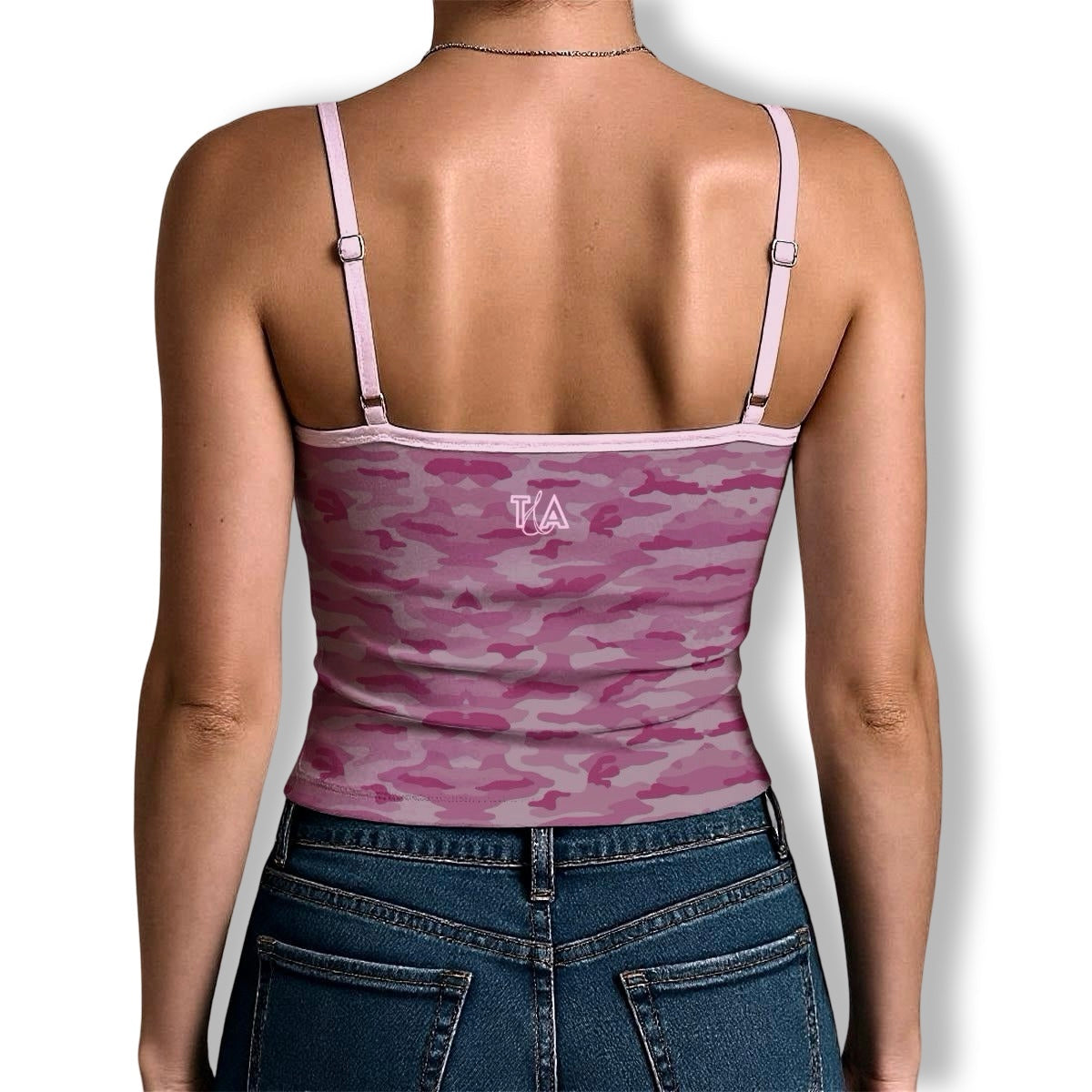 Person wearing a pink camouflage y2k cami tank top with spaghetti straps and T&A logo on a white background
