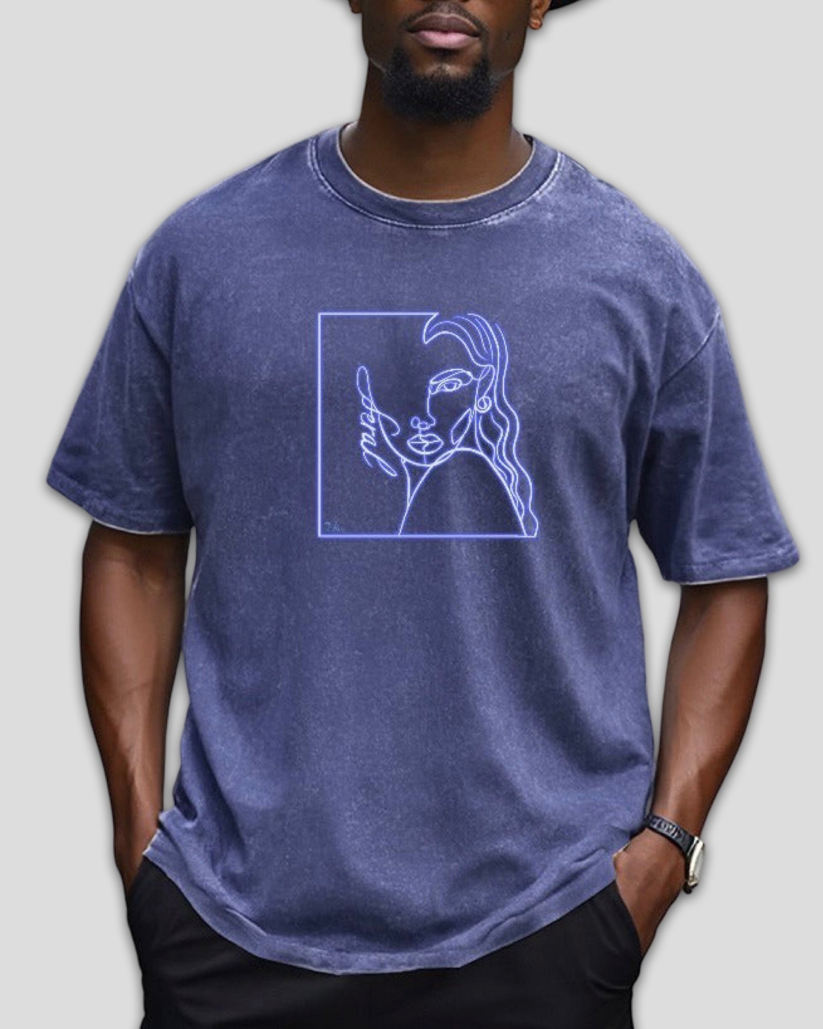 Person wearing a blue heavyweight cotton t-shirt with a graphic design on a plain background