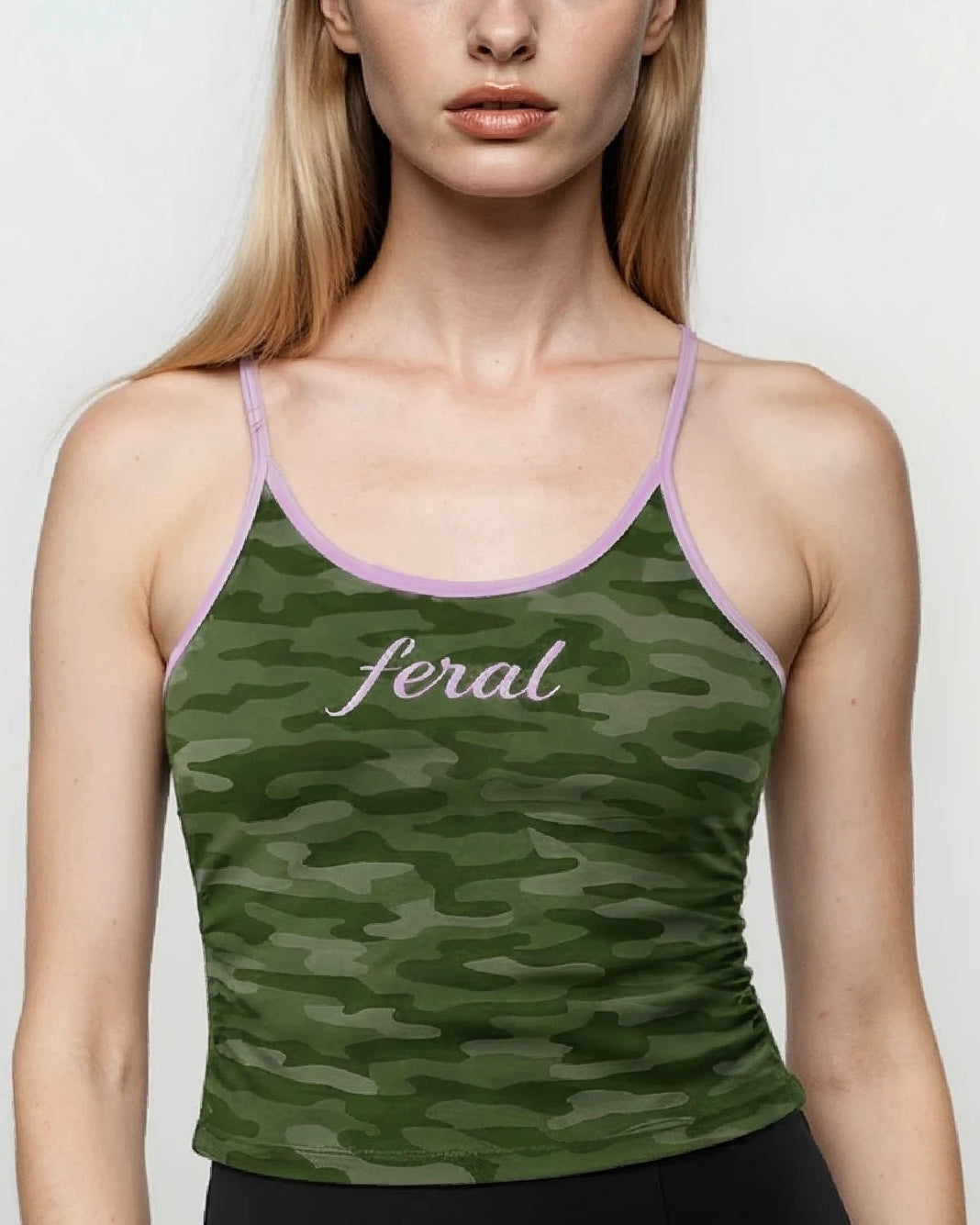 Green camouflage tank top with 'feral' text on a plain background