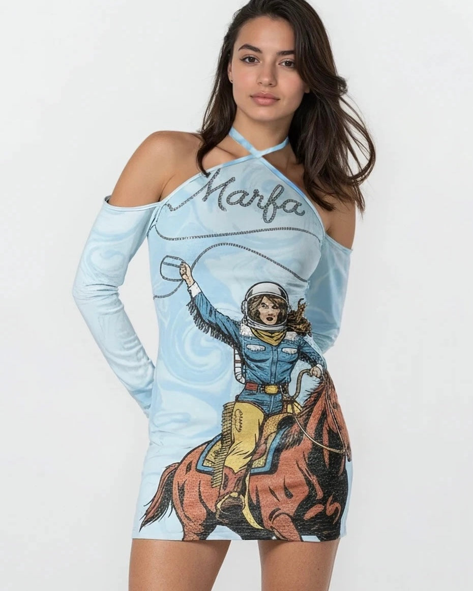 Woman wearing a blue halter dress with a cowgirl graphic design and 'Marfa' text on a white background