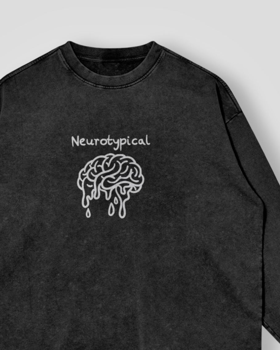 Black sweatshirt with 'Neurotypical' and brain embroidered graphic on a white background