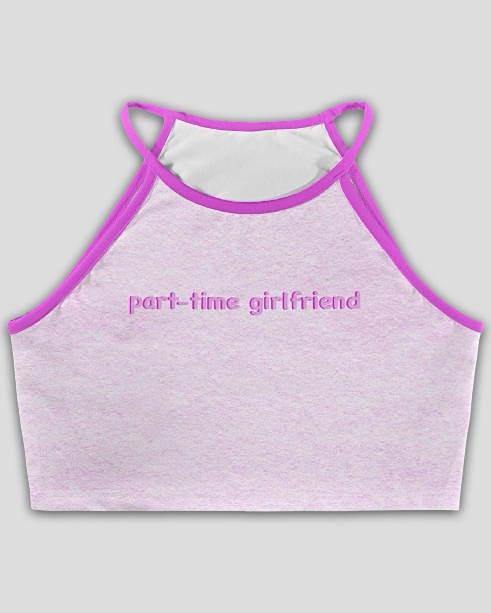 Flat lay image of a light pink halter crop top with contrast trim and text graphic that reads 