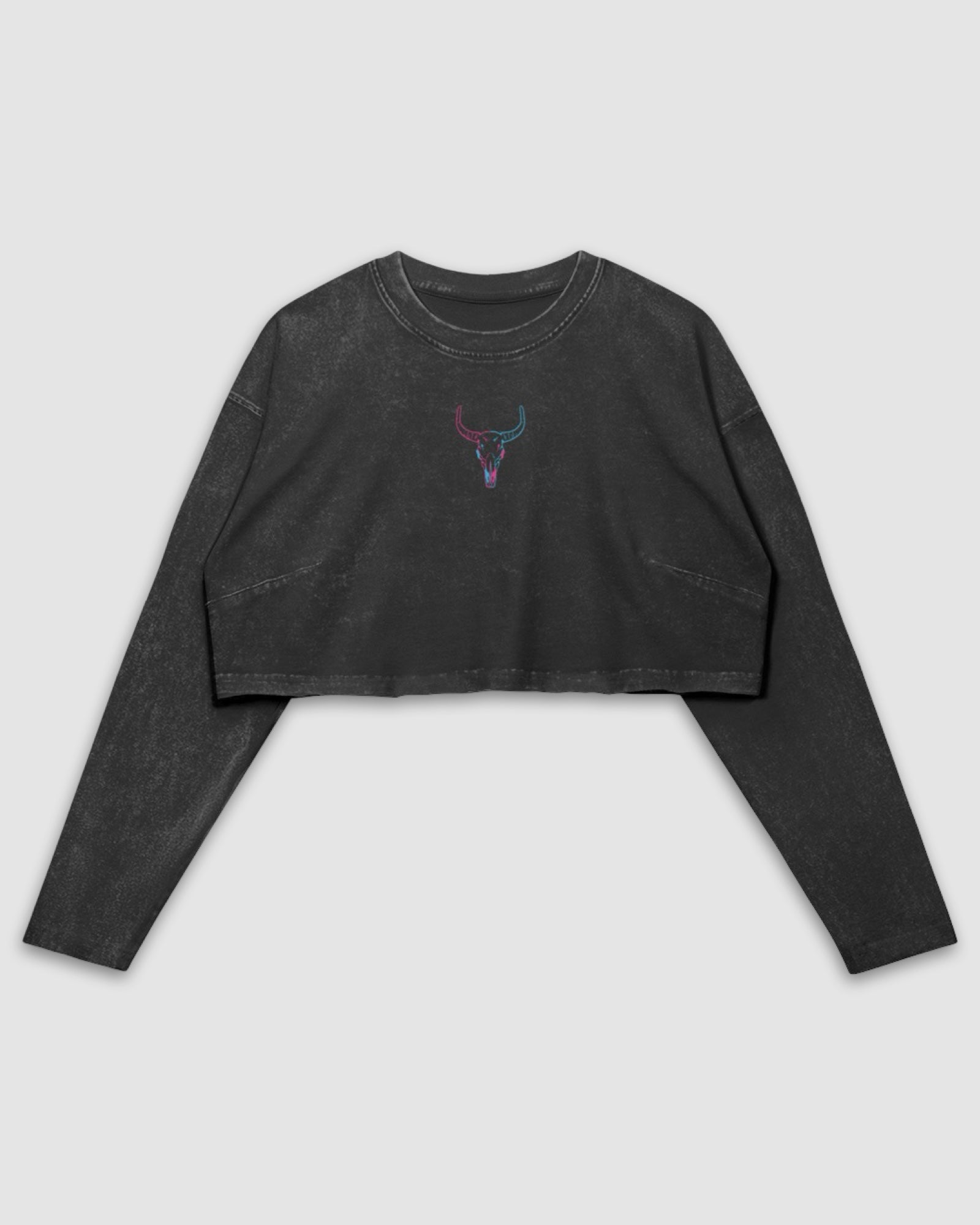 flat lay image of a long sleeve faded black cotton raw hem crop top with blue and pink embroidered original longhorn design against a white background