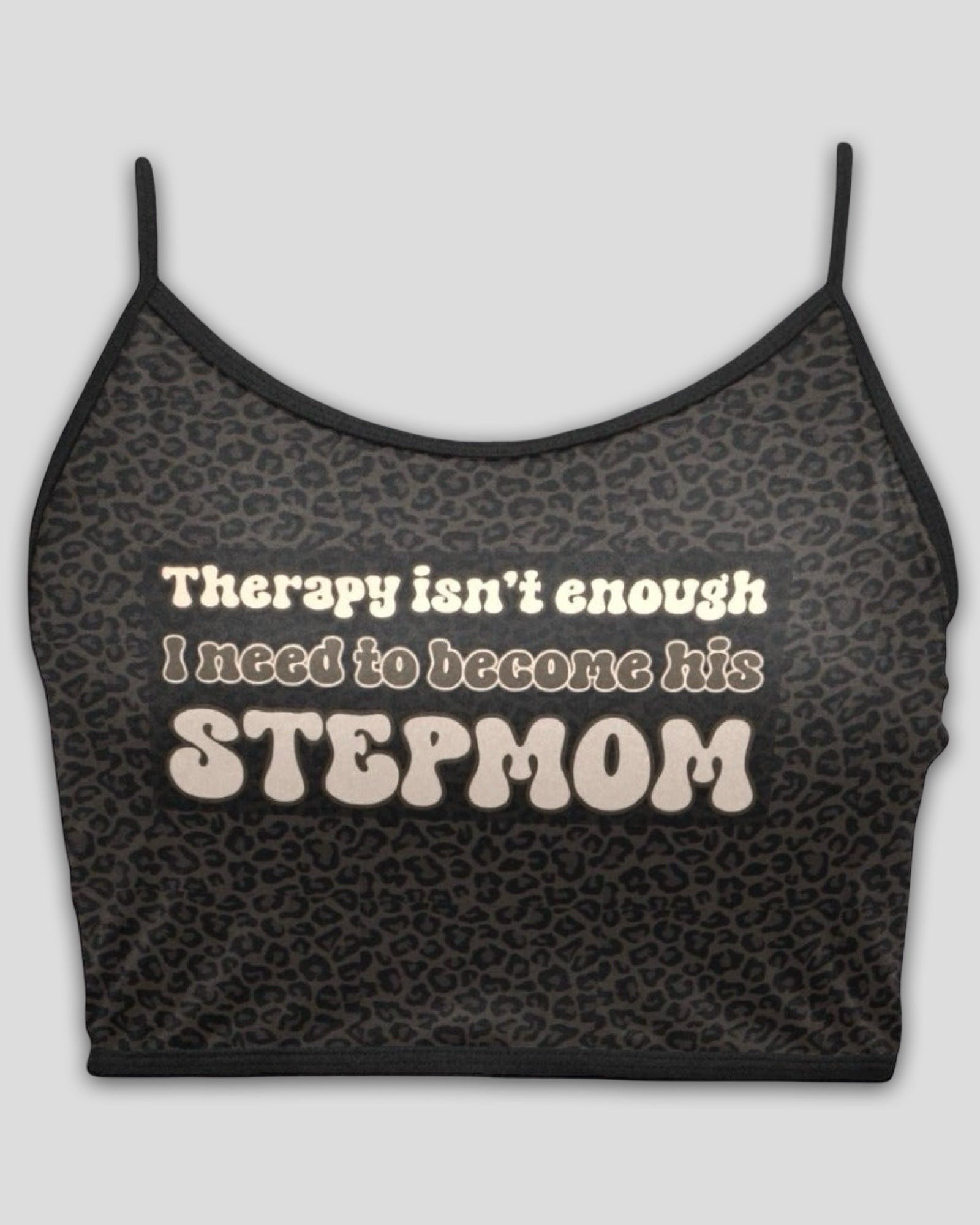 flay lay view of a dark brown leopard print spaghetti strap cami crop top with text graphic that reads 