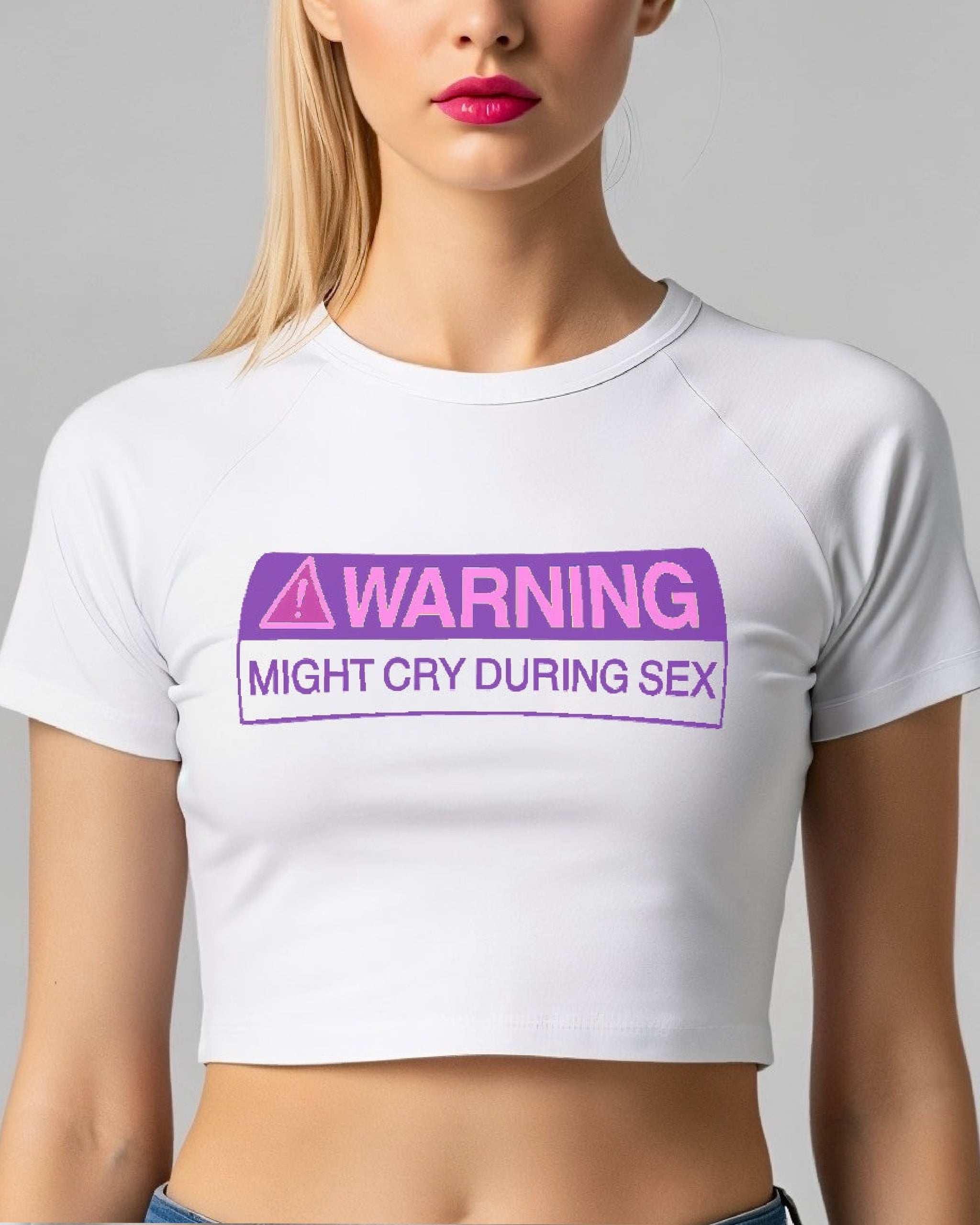 White crop top with purple 'WARNING' text on a plain background