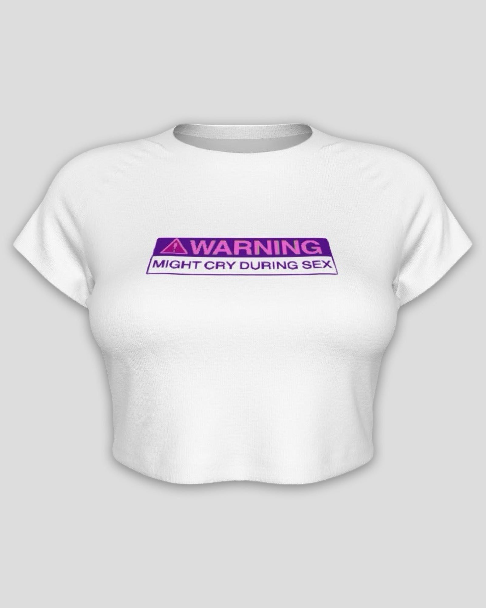 White crop top baby tee with a purple and black warning label on a light gray background